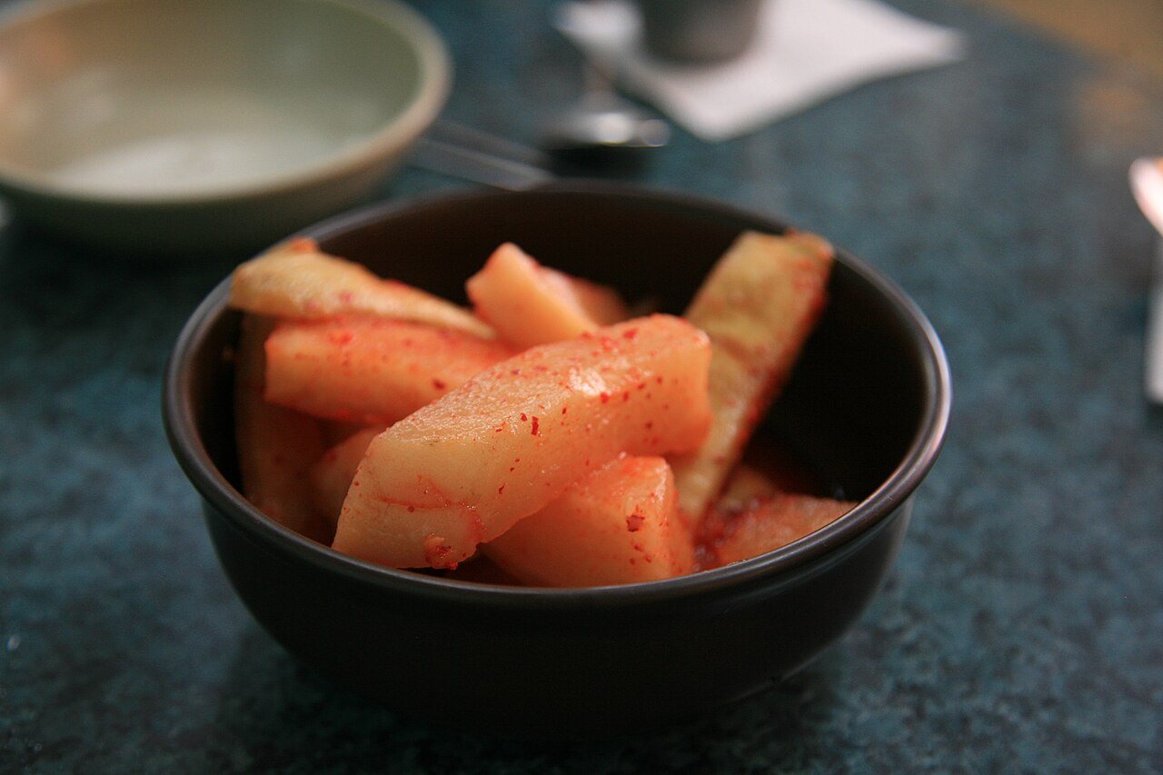 A small dish of kkakdugi, cubed radish kimchi