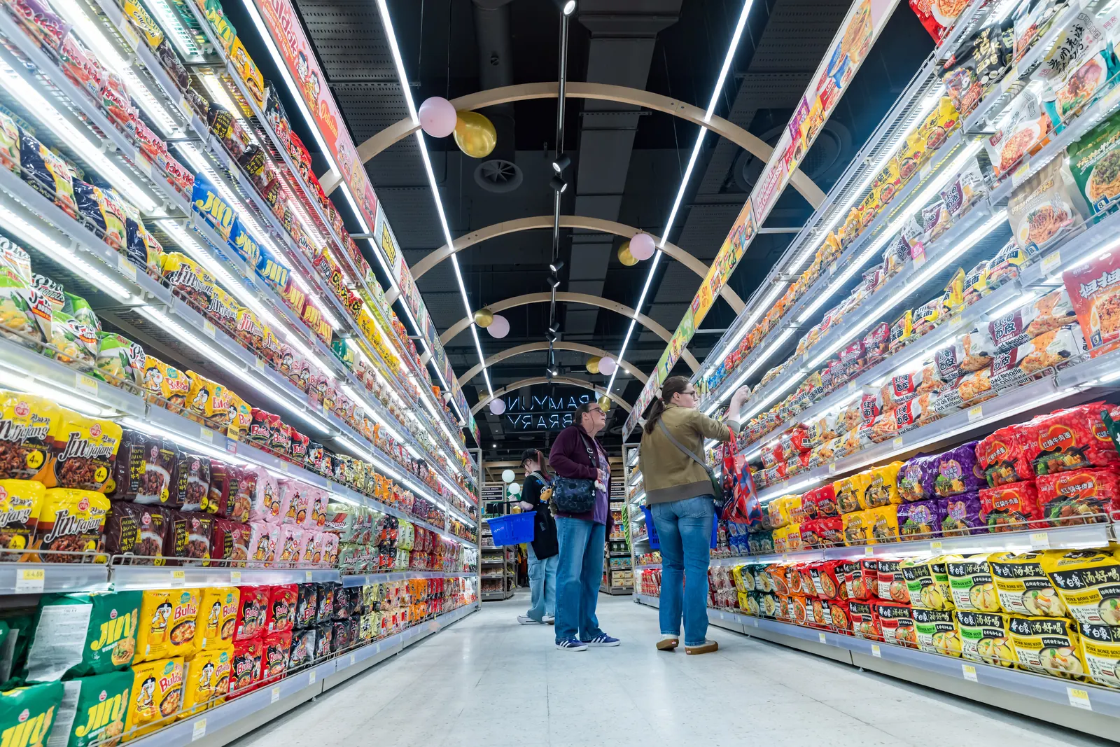 A long aisle of ramyun and snacks at Oseyo